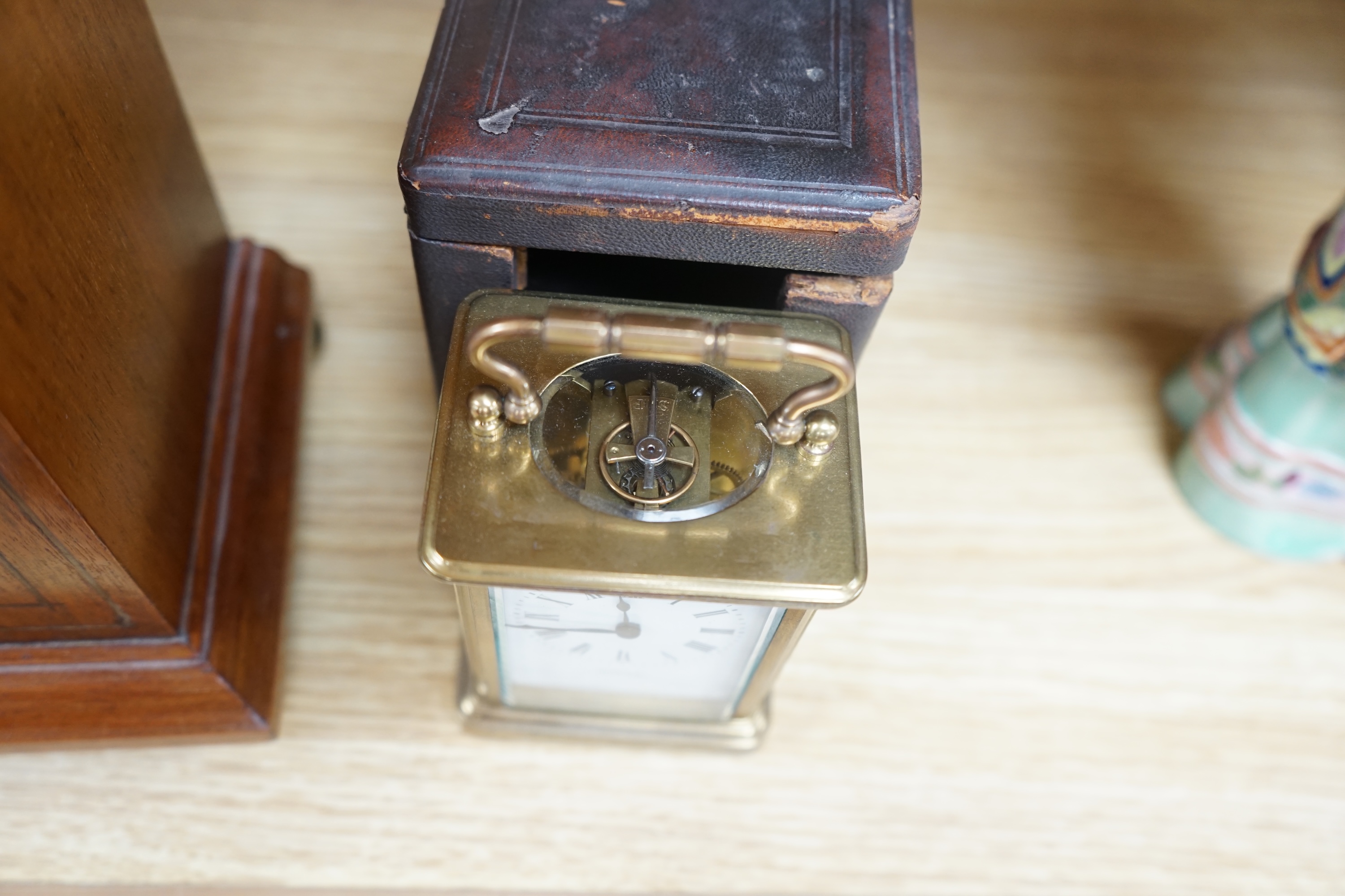 A cased brass carriage timepiece and a dome topped Edwardian mantel clock striking on a coiled gong, backplate stamped BTG, 29.5cm (2) Condition - fair to good.